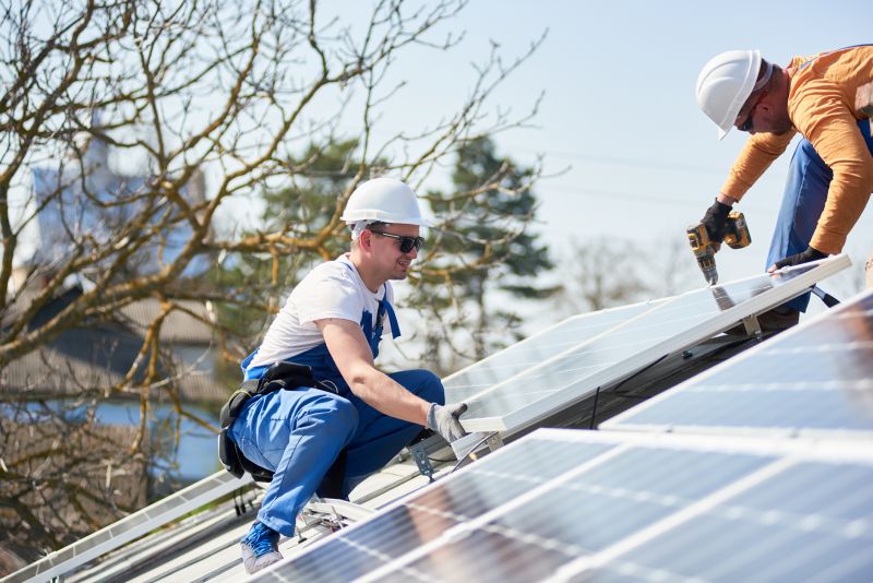 Team installing panels on a roof