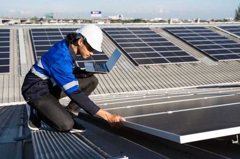 Team installing solar panels on a roof